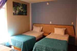 a small room with two beds in it at Hotel Los Diamantes Orizaba in Orizaba +11 photos