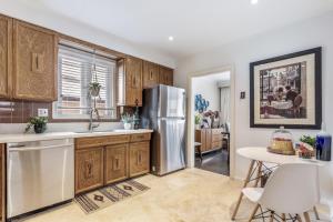 a kitchen with wooden cabinets and a stainless steel refrigerator at Vihome3001C1-3-Bedroom house facing park and school in Toronto