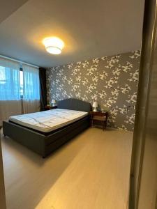 a bedroom with a bed and a wall with flowers at Casetta in Andria