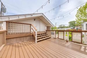 a large wooden deck with stairs and lights at Spacious St Louis Retreat 8 Mi to Downtown! in Richmond Heights