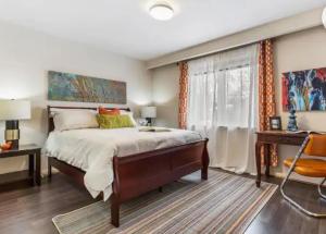 a bedroom with a large bed and a desk at Vihome3001C1-3-Bedroom house facing park and school in Toronto