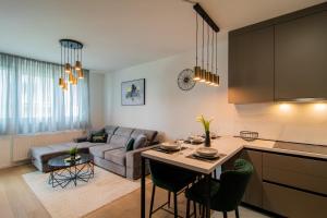 a kitchen and living room with a couch and a table at Flexible SelfCheckIns 81 - Zagreb - Arena - Garage - Loggia in Zagreb