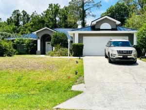 a white car parked in front of a house at Grandma’s White House in Palm Coast