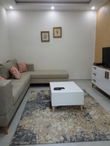 a living room with a couch and a coffee table at Ben arous one in Ben Arous