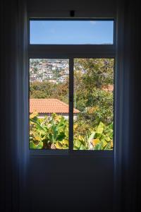 an open window with a view of a city at Achada Sol in Funchal