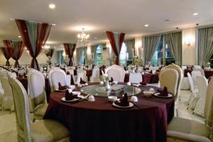 a banquet hall with tables and chairs in a room at GH Universal Hotel Bandung in Bandung