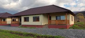 a small house is on a gravel road at Betula Apartman in Sovata