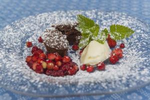 einen Teller Dessert mit Beeren und Eis in der Unterkunft Kräuterpension Säumerpfad in Mauth