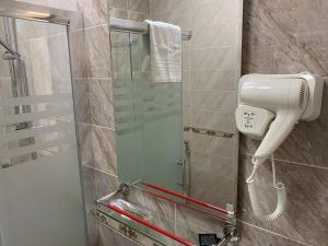 a shower with a blow dryer in a bathroom at Sahil Ark Hotel Baku in Baku