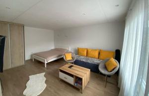 a living room with a couch and a bed at Rooms Lida & Friendly home in Plav