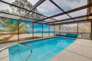 an indoor swimming pool with a view of the ocean at Screened Lanai and Heated Pool Spring Hill Home in Spring Hill
