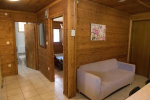 a living room with a chair and a bathroom at Garden Villa in Stavros
