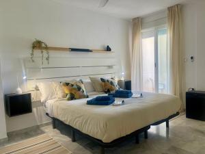 a bedroom with a large bed in a room at SOLGUEST APARTAMENTO II NAPOLEÓN vistas espectaculares!!! in Marbella +18 photos