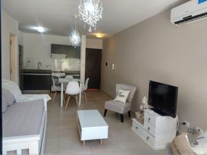 a living room with a couch and a tv at Zona residencial frente al lago! in Villa Carlos Paz
