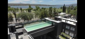 an aerial view of a building with a swimming pool at Zona residencial frente al lago! in Villa Carlos Paz
