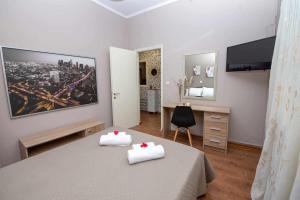 a bedroom with a bed with two white towels at Matina's Village Getaway in Antipernoí
