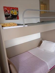 a bunk bed in a bunk bed room with a bunk bedsheet at Charoula's Apartments in Syvota