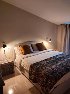 a bedroom with a large bed with two lamps at Rota's House III in Bergamo