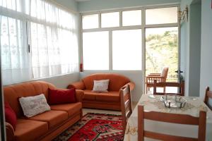 a living room with a couch and a table at EliMeliVELAJ in Përmet