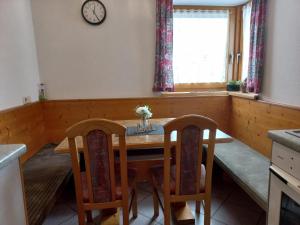 a dining room with a table and two chairs at Ferienwohnung Lechthaler Andrea in Wenns