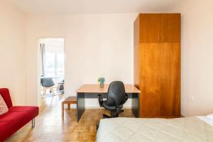 a bedroom with a desk and a red couch at Corfu Downtown in Corfu Town