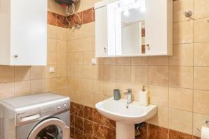 a bathroom with a washing machine and a sink at Corfu Downtown in Corfu Town +16 photos