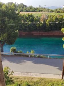 a view of a river next to a road at The house next to the canal ! in Nea Moudania