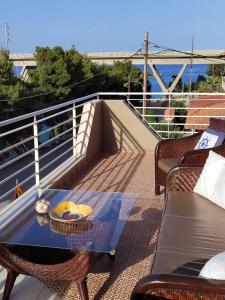 a balcony with a table and chairs on a roof at The house next to the canal ! in Nea Moudania