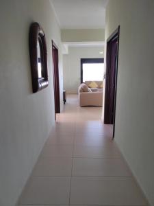 a hallway leading to a living room with a couch at The house next to the canal ! in Nea Moudania