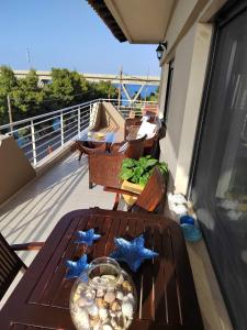 a balcony with a table with stars on it at The house next to the canal ! in Nea Moudania