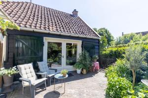 a garden shed with chairs and a patio at Ster van Bourtange in Bourtange