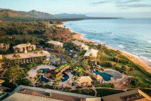 an aerial view of a resort next to the ocean at Top Floor Pool Ocean View Room at Oceanfront 4-Star Kauai Beach Resort in Lihue