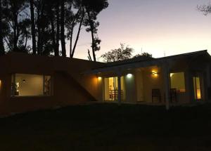 a small house with the lights on at night at Refugio Zen in Sierra de los Padres