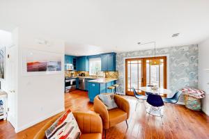 a kitchen and living room with blue walls at Victorian Dream in Arroyo Grande