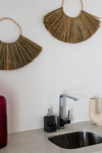 a kitchen with a sink and two baskets on the wall at Villa Pela in Aliki