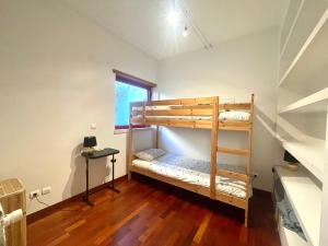 a room with two bunk beds and a window at Vila D'Alba - Sem Stress in Albufeira +34 photos
