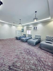 a large room with couches and a carpet at القمة العالية in Abha