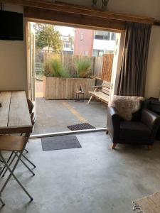 a living room with a view of a patio at Beach Cottage free parking in Noordwijk aan Zee