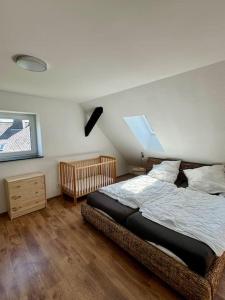a bedroom with a bed and a wooden floor at Ferienhaus Auszeit in Medebach