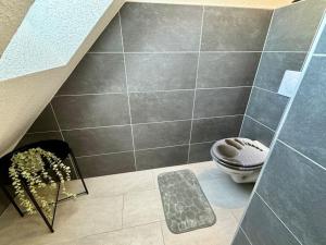 a bathroom with a toilet and a staircase at Ferienhaus Auszeit in Medebach +9 photos