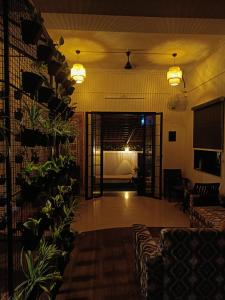 a lobby with a couch and a room with a bed at Nagarik Commune, Baner - Pune in Pune