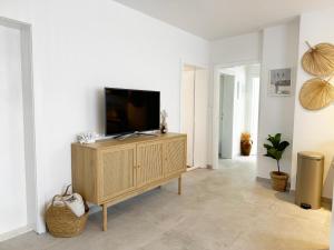 a living room with a television on a cabinet at Casa Faria in Stari Grad
