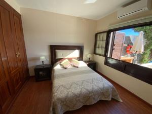 a bedroom with a bed and a large window at Villa Abuelo Paco - Private heated pool in Playa Blanca +29 photos