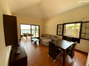 a living room with a table and a couch at Villa Abuelo Paco - Private heated pool in Playa Blanca