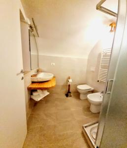 La salle de bains est pourvue d'un lavabo et de toilettes. dans l'établissement Dimora Grotta Masciarelli, à LʼAquila