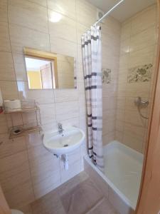a white bathroom with a sink and a shower at Noclegi u Kowala 602-793-591 in Solina