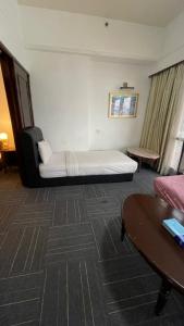 a hotel room with a bed and a table at 100 Service suites At Times Square KL in Kuala Lumpur