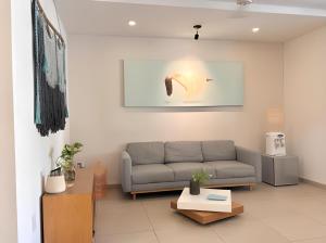 a living room with a couch and a table at Levitat 32 in Playa del Carmen