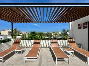 a group of chairs on a balcony with a view at Levitat 32 in Playa del Carmen