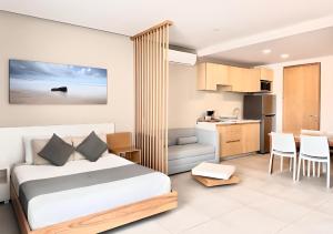 a hotel room with a bed and a kitchen at Levitat 32 in Playa del Carmen +87 photos